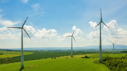Energy transition in Germany: The windmill turbines at the Windpark Druiberg in Dardesheim with the Harz Brocken Mountain in the background (Saxony-Anhalt, Germany)
