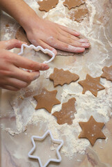 Cooking homemade cookies in the shape of a Christmas tree and a star.