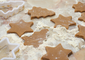 Cooking homemade cookies in the shape of a Christmas tree and a star.