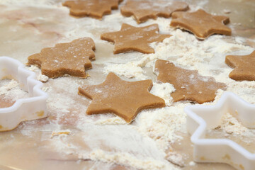 Cooking homemade cookies in the shape of a Christmas tree and a star.