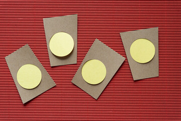brown paper shapes with yellow paper circles on corrugated texture