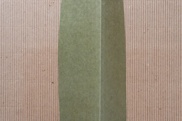 isolated green paper shape on brown corrugated paper