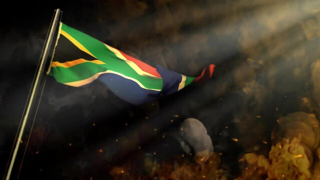 waving South Africa flag on smoke and fire with sun rays - cataclysm concept