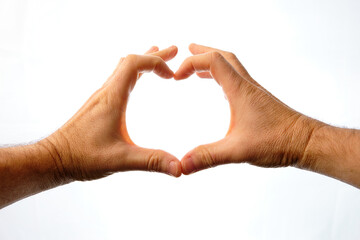 Man's hands making a heart on a white background.
