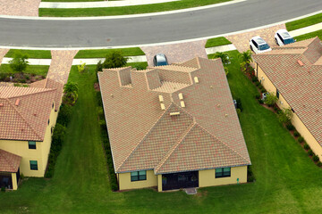 Aerial view of typical contemporary american private house with roof top covered with ceramic...