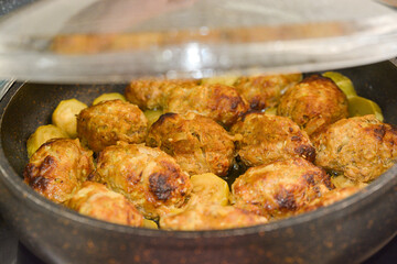 Hot stew meatball with vegetables in tomato sauce closeup in a pot on the table. 