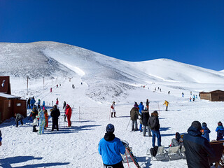 skiers on resort of Falakro mountain, full of snow in Drama city of North Greece