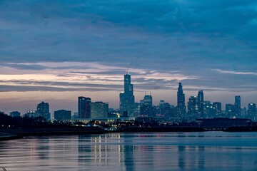 Obraz premium Downtown Chicago and Lake Michigan During the Blue Hour as viewed from just off of Lake Shore Drive near the 49th Street Beach