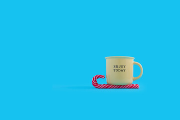 Minimal Christmas concept with candy cane and coffee mug.	