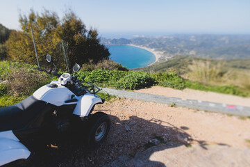 Group of riders riding ATV vehicle crossing mountain serpentine road track, process of driving rental vehicle, all terrain quad bike vehicle, during off-road tour, Greece, Ionian sea islands © tsuguliev