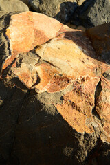 Geological formation of colorful stones with different layers, sand, fossil rocks on Magoito beach, Atlantic ocean coast near Lisbon