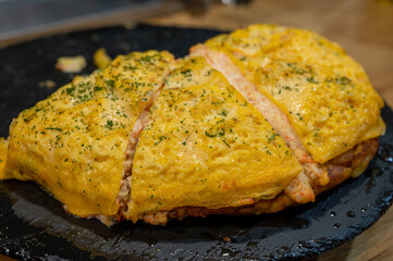 Typical snack of Basque Country, pinchos or pinxtos, small piece of bread with egg omelette, different toppings, served in bar in San-Sebastian or Bilbao, Spain