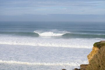 Magoito Beach during storm and high waves, beautiful sandy beach on Sintra coast, Lisbon district, Portugal, part of Sintra-Cascais Natural Park with natural points of interest