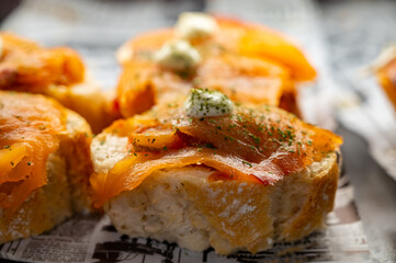 Typical snack of Basque Country, pinchos or pinxtos skewers with small pieces of bread, sea food, eggs, cheese, jamon served in bar in San-Sebastian or Bilbao, Spain