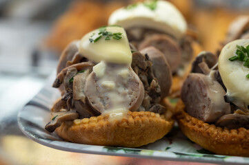 French mini quiche pie with goat cheese and traditional French sausage Andouillette from Troyes in bakery