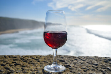 Tasting of tawny porto wine and   view on sandy beach and blue Atlantic ocean near Sintra in Lisbon...