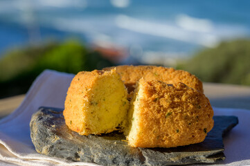 Codfish croquette pastais de bacalhau, traditional portuguese snack food served outdoor with view...