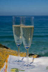 Glasses of champagne sparkling wine and view on blue Atlantic ocean, Lisbon area, Portugal