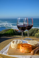 Food and wine pairing, red dry Portuguese wine and variety of goat, sheep, cow cheeses made with paprika, herbs in Portugal