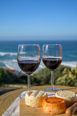 Food and wine pairing, red dry Portuguese wine and variety of goat, sheep, cow cheeses made with paprika, herbs in Portugal