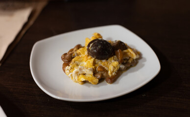 Homemade scrambled eggs with forest mushrooms