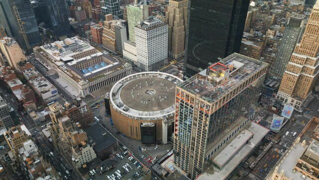 High angle view of buildings in metropolis. Cylindrical structure of famous multifunctional indoor arena Madison Square Garden. New York City, USA