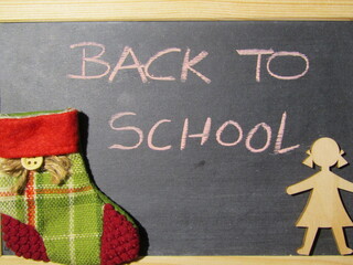 blackboard with christmas decoration, christmas sock and a wooden girl, child