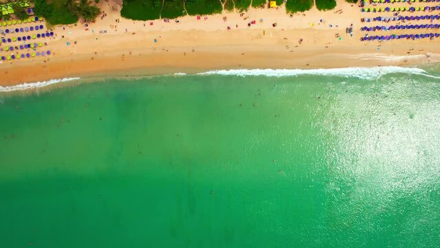 Drone flying over the beach, Beautiful turquoise waves crashing on the beach. Many tourists from all over the world. Nai Harn beach, Phuket, Thailand. beach background. Travel and Nature concept. 4K

