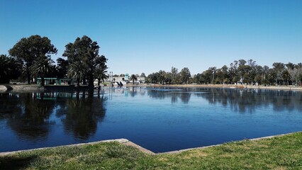 Lake with palm trees, island with vegetation, blue sky