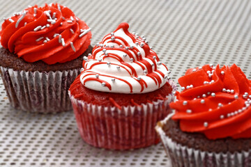 creamy cupcake in shades of red on white background