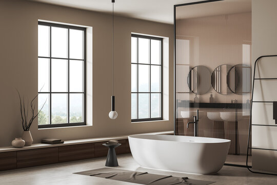 Light bathroom interior with tub and glass partition, panoramic window