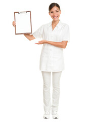 Nurse showing blank clipboard sign - a medical concept. Woman doctor / nurse smiling isolated...