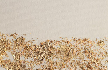 Gold (bronze) glitter, beige empty paper canvas background. Abstract copy space texture.