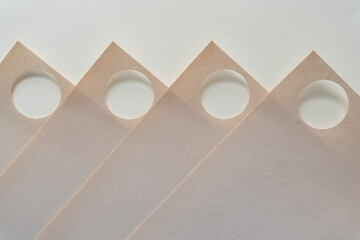 old scratch pad sheets with holes arranged in zig zag form on blank paper