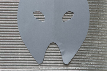 theatrical mask on corrugated texture