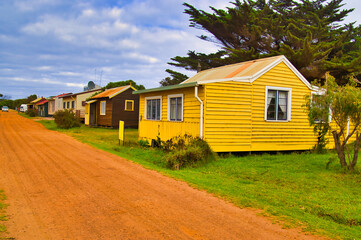 Fototapeta na wymiar Street scene with simple, colorful wooden houses in the village of Pemberton, Western Australia 