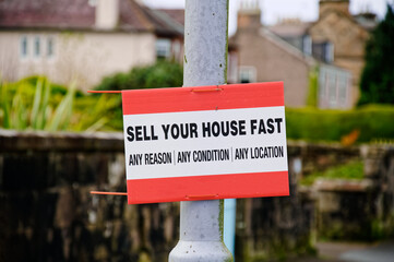Sell your house fast sign outside residential area during property crisis - obrazy, fototapety, plakaty