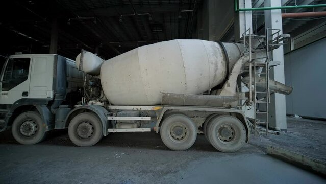 The concrete mixer at the industrial plant. Builders are building a factory, hangar.