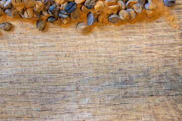 Coffee Beans and Chocolate Chips as a background pattern on Wood with cinnamon