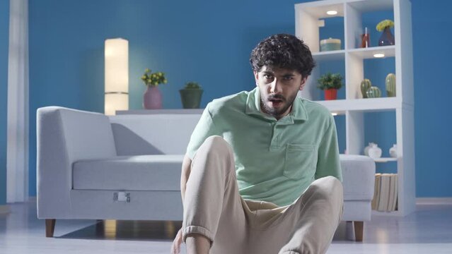 The mentally ill teenager becomes paranoid and flees in doubt and fear.
Young man with schizophrenia and paranoid is going crazy at home, having seizures, hallucinations.
