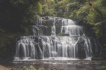 Fototapeta na wymiar Wide waterfall among trees