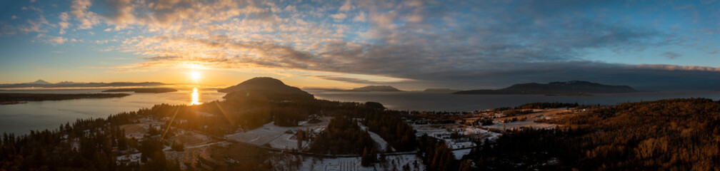 Aerial Winter Sunrise Over Hale Passage and Lummi Island. Snow blankets this lovely small island located minutes from Bellingham, Washington and accessed by a twenty one car ferry boat. 