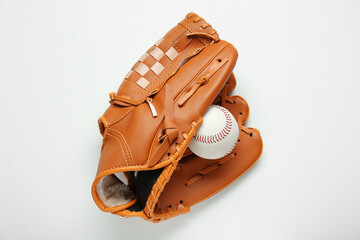 Catcher's mitt and baseball ball on white background, top view. Sports game