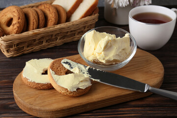 Tasty homemade butter, cookies and tea on wooden table