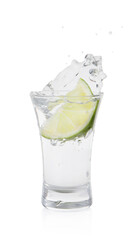 Vodka splashing out of shot glass with lime on white background