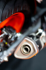 Closeup of the end of the pipe of a modern motorcycle