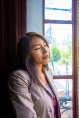 horizontal photo business brunette woman relaxed and happy breathing fresh air in a window