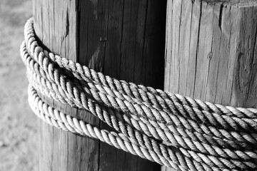 Fototapeta na wymiar Ropes tied tightly around wood poles