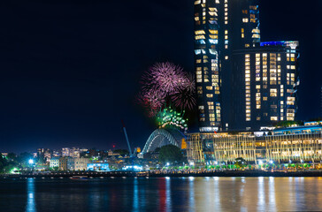 Fototapeta na wymiar Sydney Harbour Bridge New Years Eve fireworks, colourful NYE fire works lighting the night skies with vivid multi colours NSW Australia. Happy New Year. New Year Eve