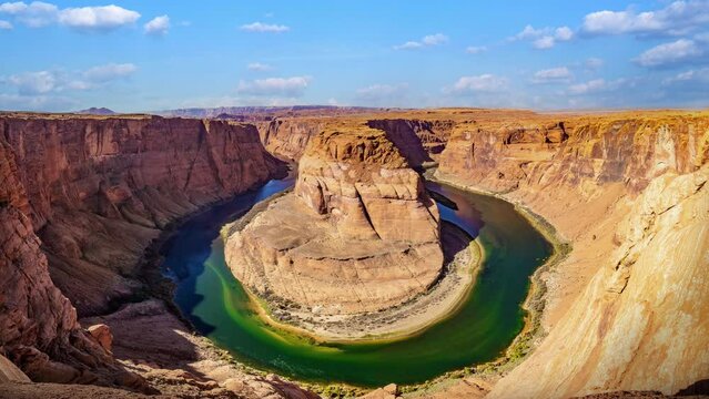 Beautiful time lapse of Horseshoe Bend on the Colorado river on a sunny day. The most iconic tourist attraction of the Grand Canyon in Page, Arizona, USA.